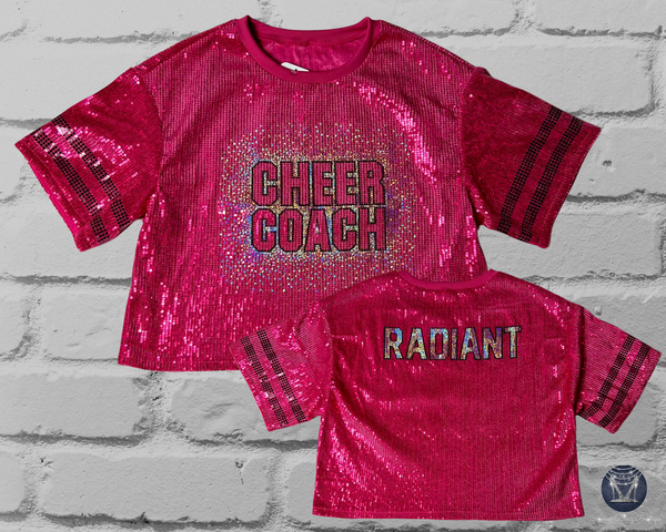 Dark Pink sequin jersey with 'CHEER COACH' on front and 'RADIANT' text on back in holographic silver and black spangle bling on a brick wall background