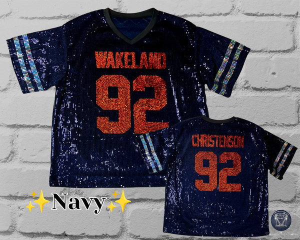 Two navy blue sequined football jerseys displayed against a white brick wall background. The larger jersey on the left reads 'WAKELAND 92' and the smaller jersey on the right reads 'CHRISTENSEON 92'.