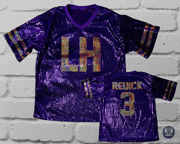A purple sequined football-style jersey shown from the front and back, with large 'LH' lettering on the front, 'REDICK' and number '3' on the back, and striped sleeve accents, displayed against a white brick wall.