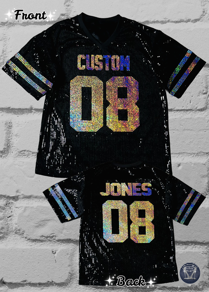 Black custom football-style sequin jersey shown from the front and back, with custom holographic sequin numbers and lettering  plus striped bling silver sleeve accents, displayed against a white brick wall.