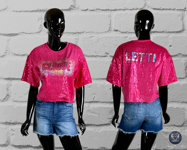A dark pink sequined crop top shown on black mannequins from the front and back, paired with denim shorts against a white brick wall. The front reads 'CLIQUE' and the back reads 'LETTI'.