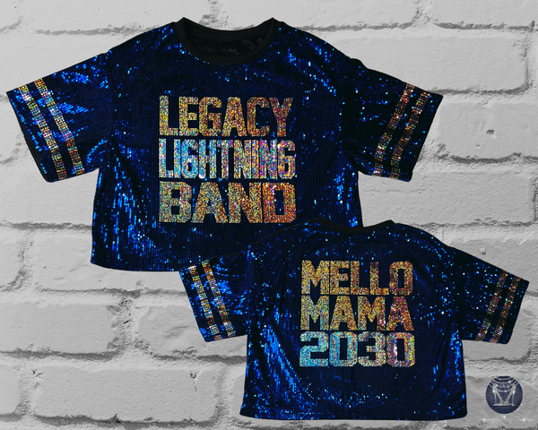 Front and back view of blue sequin mid-crop jersey against a white brick wall.
Front: LEGACY LIGHTNING BAND in gold and silver bling
Back: MELLO MAMA 2030 in gold and silver bling
Sleeve stripes: gold bling