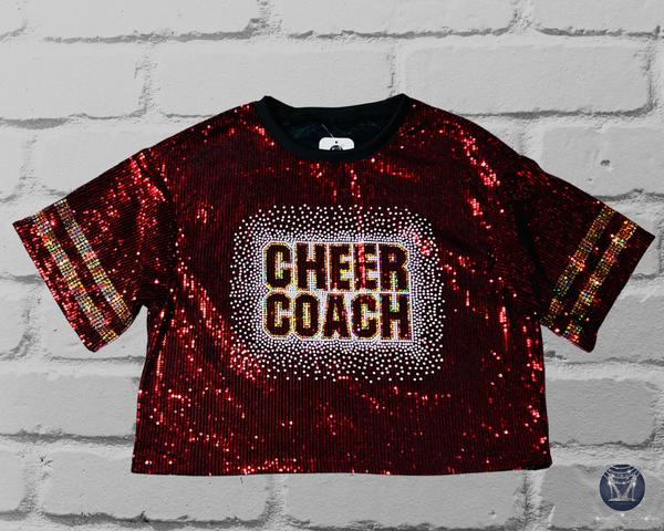 Burgundy sequin jersey with 'CHEER COACH' on front in holographic white and gold spangle bling on a brick wall background