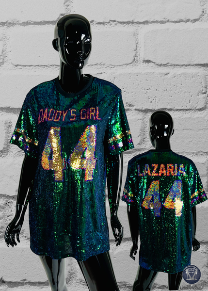 Two mannequins wearing sequin jerseys with personalized text against a brick wall.