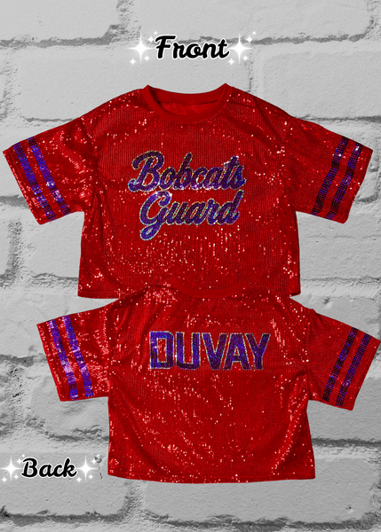 A red sequined short-sleeve jersey top shown from both front and back on a light gray brick background. The front reads "Bobcats Guard" in blue script, and the back reads "DUVAY" in blue and silver block letters with blue sleeve stripes.