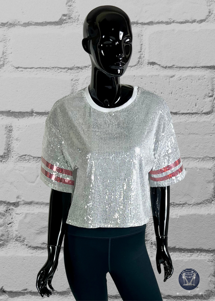 White sequin jersey on a black mannequin on a brick wall background